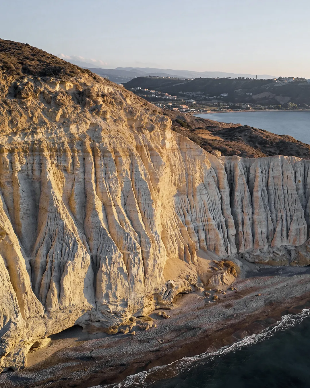Golden coastal cliffs at sunset along the Paphos shoreline