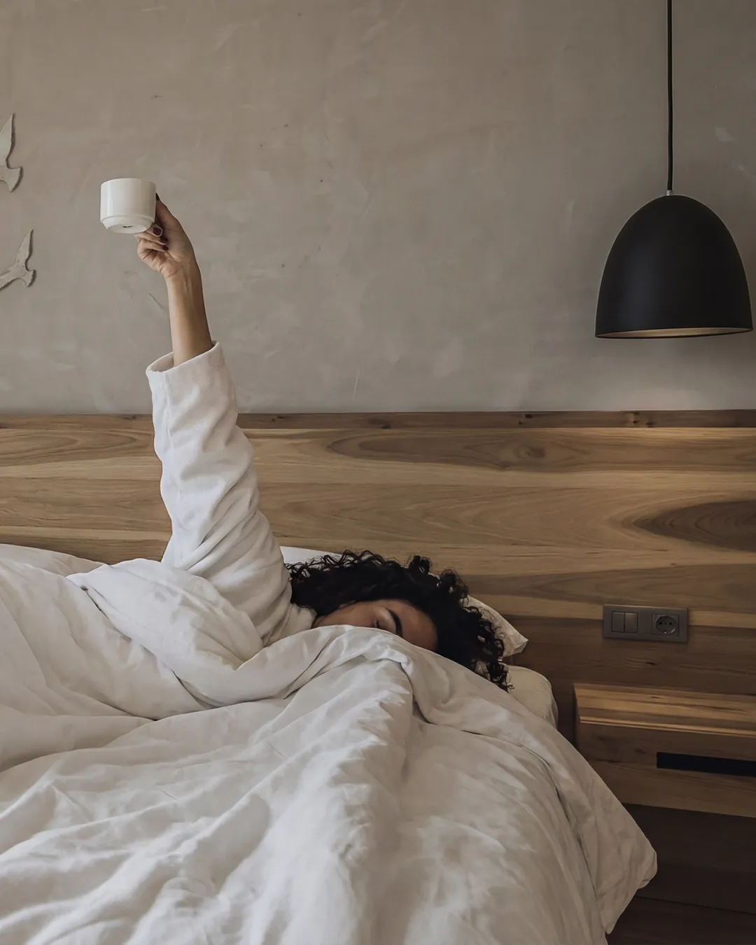 Morning coffee ritual in bed